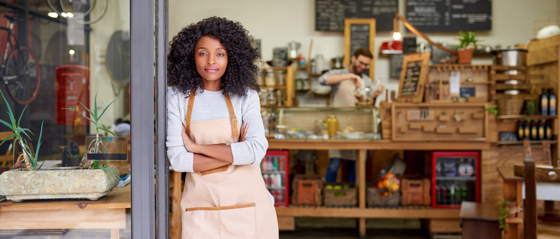 Woman standing by a shop door